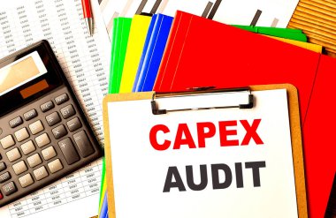 CAPEX AUDIT text on a clipboard with calculator and color folder .  clipart