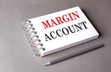 MARGIN ACCOUNT text on notebook on a grey background .  clipart