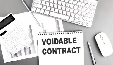  Voidable contract concept with calculator, keyboard, notebook, and pen on office desk .  clipart