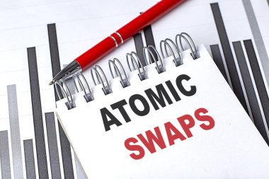 Kripto para birimini temsil eden kırmızı kalemle finansal tablolarda metin atomik takasları olan bir defter .
