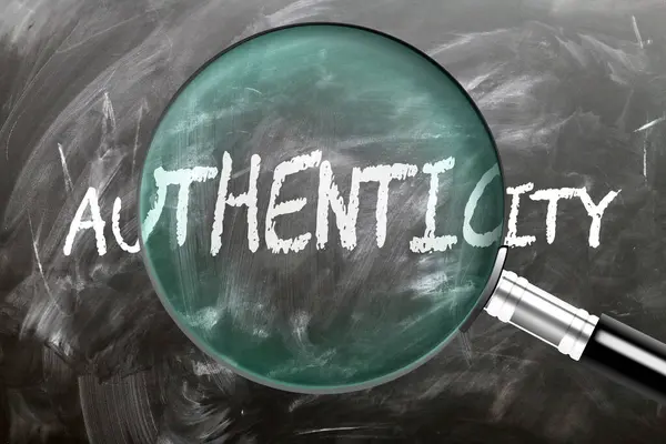 stock image Authenticity - learn, study and inspect it. Taking a closer look at authenticity. A magnifying glass enlarging word 'authenticity' written on a blackboard