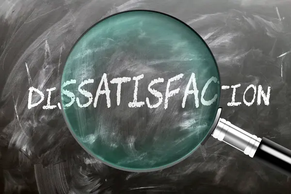 stock image Dissatisfaction - learn, study and inspect it. Taking a closer look at dissatisfaction. A magnifying glass enlarging word 'dissatisfaction' written on a blackboard