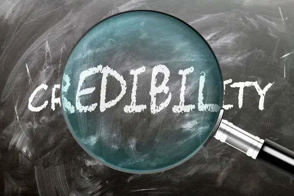 stock image Credibility - learn, study and inspect it. Taking a closer look at credibility. A magnifying glass enlarging word 'credibility' written on a blackboard