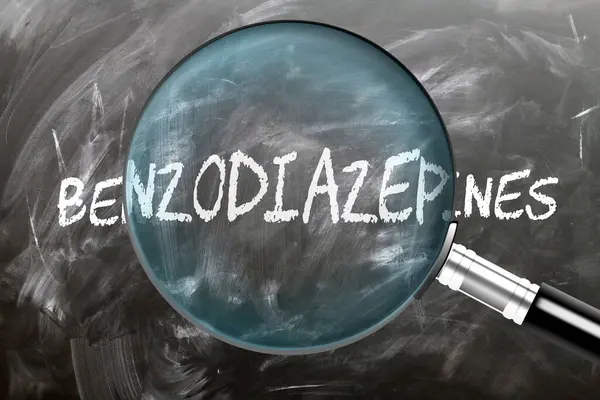 stock image Benzodiazepines - learn, study and inspect it. Taking a closer look at benzodiazepines. A magnifying glass enlarging word 'benzodiazepines' written on a blackboard