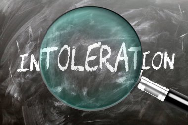 Intoleration - learn, study and inspect it. Taking a closer look at intoleration. A magnifying glass enlarging word 'intoleration' written on a blackboard