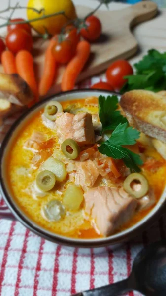 Creamy salmon soup with vegetables. Traditional Finnish hot soup