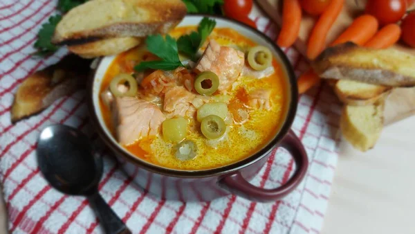 Creamy salmon soup with vegetables. Traditional Finnish hot soup