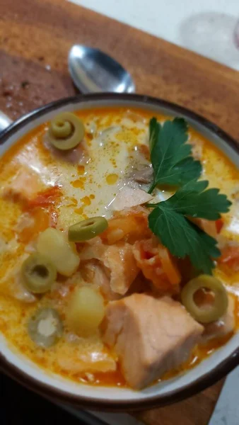 Creamy salmon soup with vegetables. Traditional Finnish hot soup