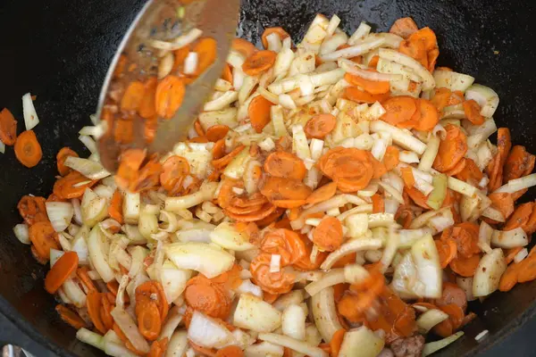 stock image      Vegetables are fried in a pan on the stove. Pan-fried carrots with vegetables                          