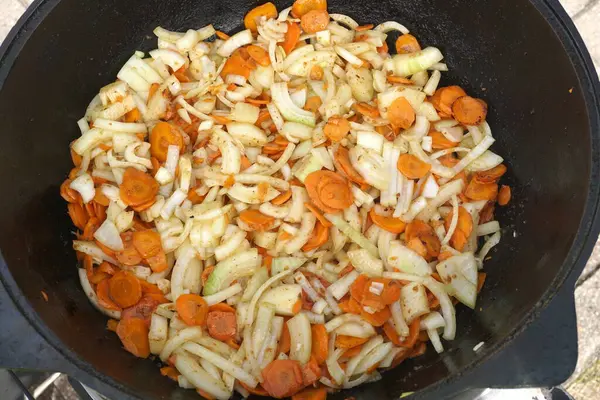 stock image      Vegetables are fried in a pan on the stove. Pan-fried carrots with vegetables                          