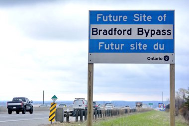 Ontario, Canada, May 2, 2022: A highway sign for the Bradford Bypass on highway 400 in central Ontario. This bypass has been criticized for its potential environmental impact in the Holland Marsh. clipart