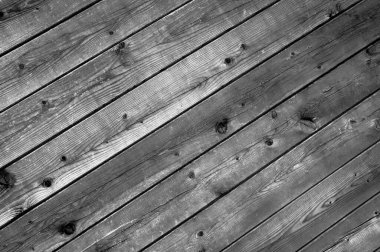 Old weathered wooden diagonal planks with grey color