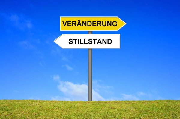 Signpost Showing Change Standstill German Language — Stock Photo, Image