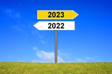 Signpost yellow and white showing year 2022 and year 2023