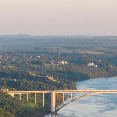 Border between Brazil and Paraguay and connects Foz do Iguacu to Ciudad del Este. Ponte da Amizade in Foz do Iguacu. Aerial view of the Friendship Bridge with Parana river. Square image. clipart