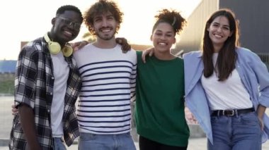 Group of young diverse multi-ethnic friends enjoying good moments and having fun together outdoors in the city at sunset - Youth Portrait