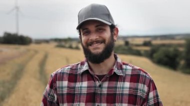 Farmer in the wheat field looking to camera with smile - Professional Worker Portrait