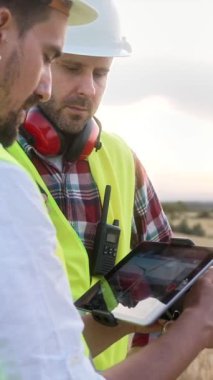 Endüstriyel bakım için hava teknolojisi tablet ekran uzaktan kumandalı uzaktan kumandalı insansız hava aracı uçuşu uygulaması mühendisler tarafından çalıştırılıyor.