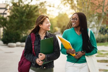 Uluslararası Asyalı ve Afrikalı Amerikalı öğrenci arkadaşlar okula geri dönüyorlar.