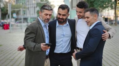 Elegant businessmen friends taking selfie photo with mobile phone after business meeting celebrating agreement 