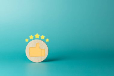 Wooden with thumbs up and five star rating icon on blue background. Service rating, satisfaction concept