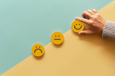 Customer show smile face emoticon for rating. Service rating, feedback, satisfaction concept