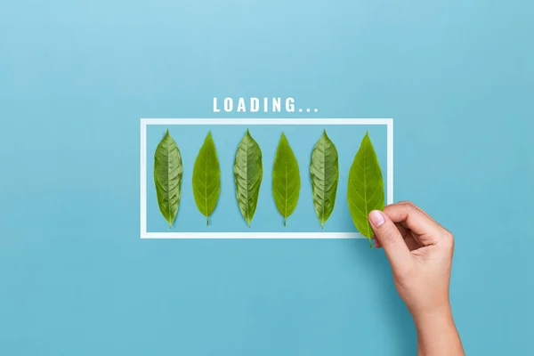 Loading status. Hand putting leaf for loading the progress bar on blue background