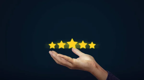 Hand of client show a feedback with five star rating for rating. Service rating, satisfaction concept