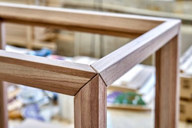 Atölyede sağlam cevizden yapılmış komodinin ahşap çerçevesi. Döşeme üzerindeki kalasların açısal birleşimi yakın plan