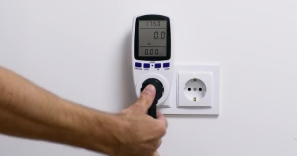 Person Sticks Device Plug Outlet Home Wattmeter Measuring Power Consumption — Vídeo de stock