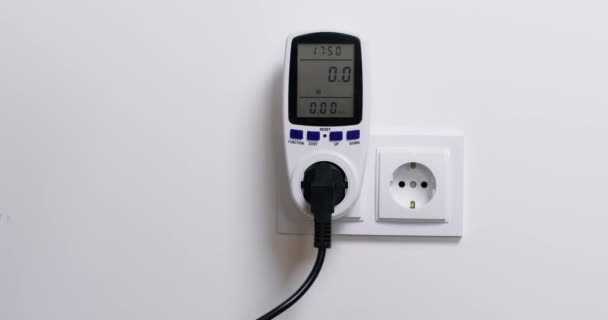 Man Plugs Outlet Home Wattmeter Measuring Power Consumption Tries Compare — Video Stock