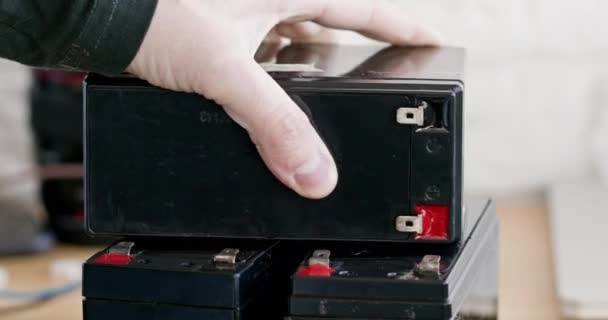 Male Hand Puts Accumulator Batteries Workshop Closeup Charging Equipment Store — Stock videók