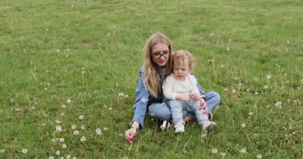 Mère Blonde Fils Tout Petit Assis Dans Prairie Fleurs Vertes — Video