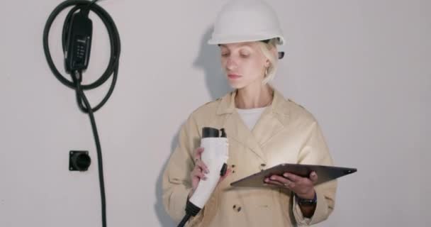 Woman Engineer Helmet Checks Electric Vehicle Charging Station Holding Tablet — Stock videók