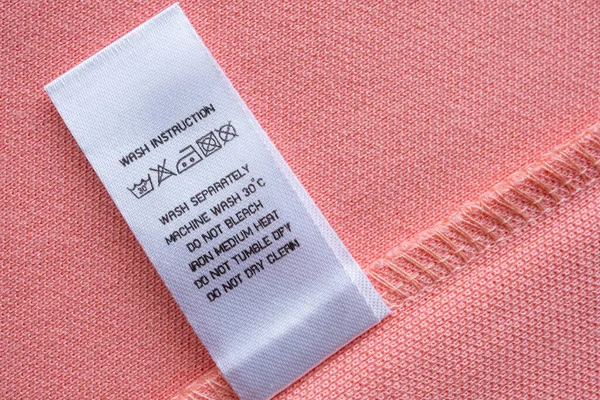 White Laundry Care Washing Instructions Clothes Label Pink Cotton Shirt — Foto de Stock