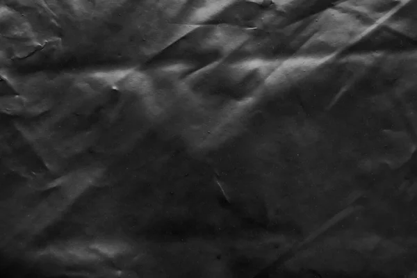 透明塑料袋包覆在黑色背景上的纹理 — 图库照片