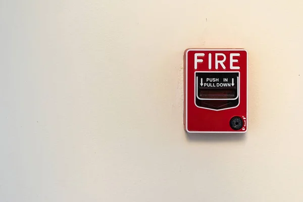 Fire alarm switch on white wall background