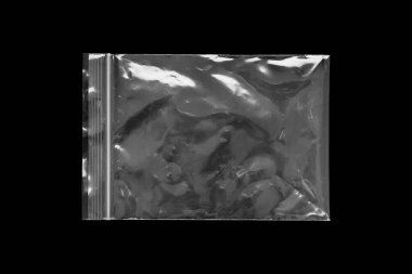 Blank transparent plastic bag overlay on black background
