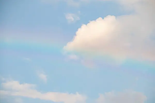 Beautiful rainbow with clouds and blue sky