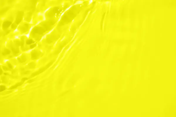 Abstract transparent water shadow surface texture natural ripple on yellow background