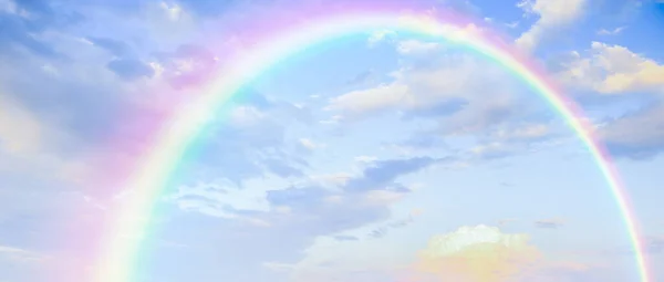 Beautiful rainbow with clouds and blue sky