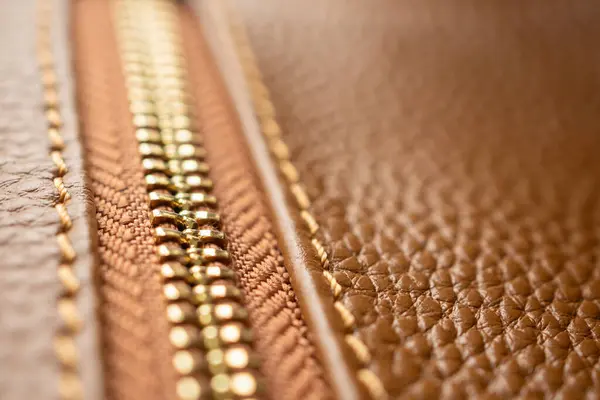 stock image close up of zipper on brown leather bag