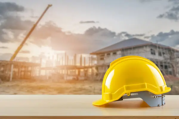 Yellow Safety Construction Helmet Wood Table Construction Site Background Stock Photo
