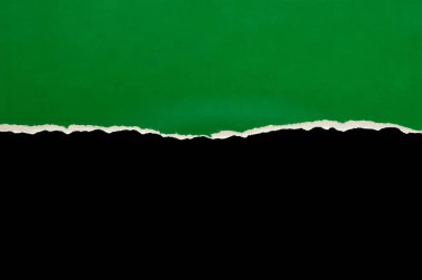 Yırtık yeşil kağıt kenarları siyah arkaplanda izole edilmiş.