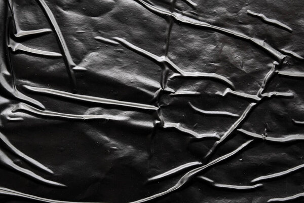 черный скомканный и складчатый пластиковый фон плаката текстуры