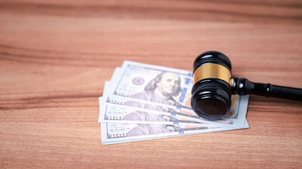 The gavel on a dollar bill in a courtroom represents the complex interplay between alimony law, alimony taxes, financial power, highlighting the need for clear legal frameworks, ethical considerations