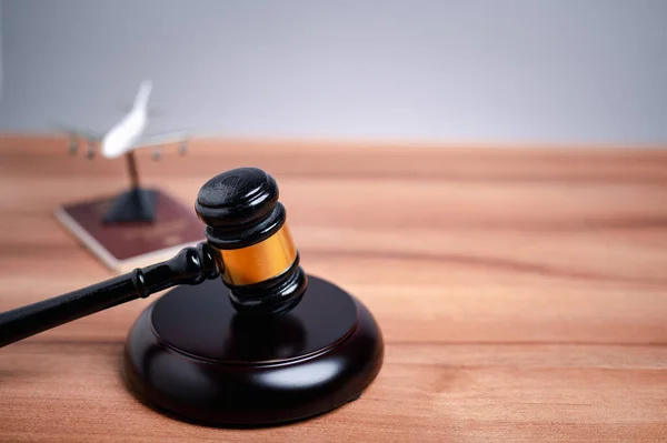 The immigration officer brought down the gavel of justice on the table, symbolizing the importance of following immigration law and the consequences of breaking it.