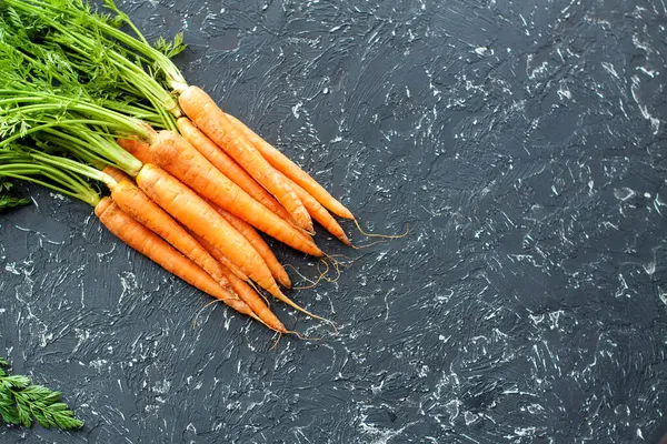 Fresh carrots bunch on stone table
