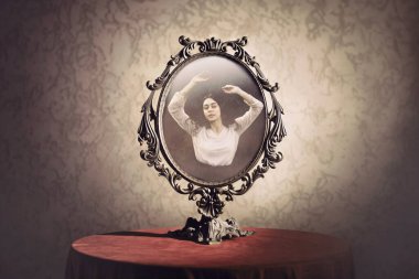 mirror with the reflection of a woman who is enraptured by her own beauty, concept of vanity clipart