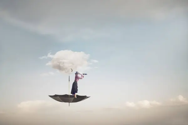 云带着超现实的伞把一个女人带向天空 抽象的概念 图库图片